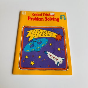 May include: A yellow book cover with the title "Critical Thinking Problem Solving" in black text. The book is for grades 5-6 and features a colorful illustration of a spaceship flying through space with stars and planets.