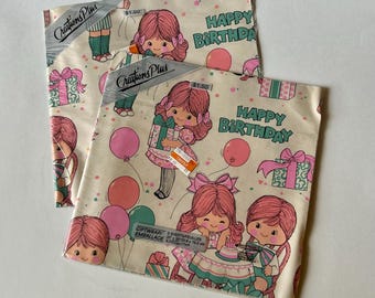 May include: Two folded sheets of cream-colored gift wrap featuring a repeating pattern of cartoon girls with pink hair, pink and teal balloons, and wrapped presents. The text "HAPPY BIRTHDAY" and "Creations Plus" is printed on the paper.