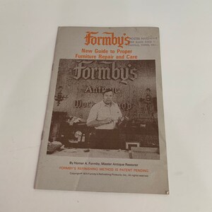 May include: A vintage guide to furniture repair and care by Homer A. Formby, Master Antique Restorer. The cover features a photo of a man in a workshop with the text "Formby's Antique Workshop".