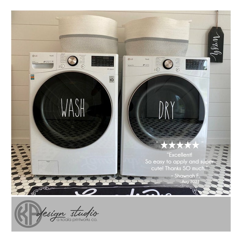 May include: White washer and dryer with black text that says "WASH" and "DRY" on the front. The washer and dryer are in a white tiled laundry room with a black and white patterned rug.