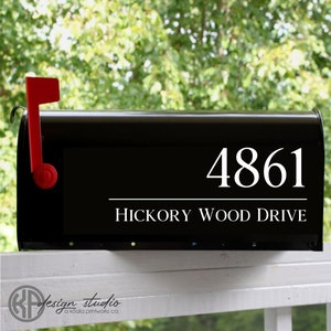 May include: Black mailbox with a white address number 4861 and the text "Hickory Wood Drive" in white.