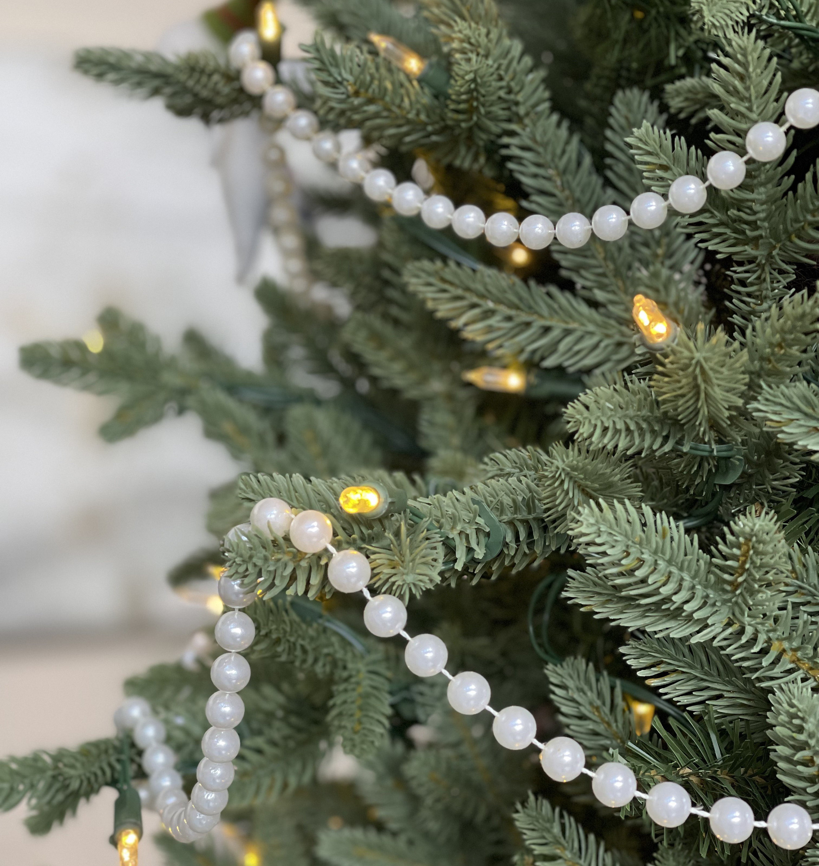 Balsam fir Christmas tree with faux pearl bead garlands double swags  interspersed w/garlands o…