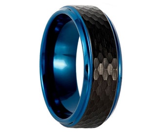 May include: A blue and black tungsten carbide ring with a hammered finish. The ring has a beveled edge and a polished interior.