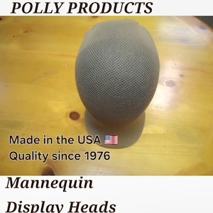 May include: A green mesh mannequin head for displaying hats. Made in the USA. Quality since 1976. Mannequin Display Heads.
