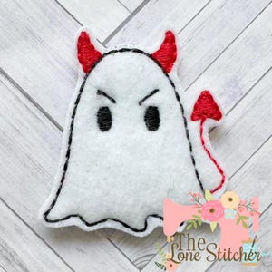 May include: A white felt ghost with red devil horns and a tail. The ghost has black eyes and a frowning mouth.