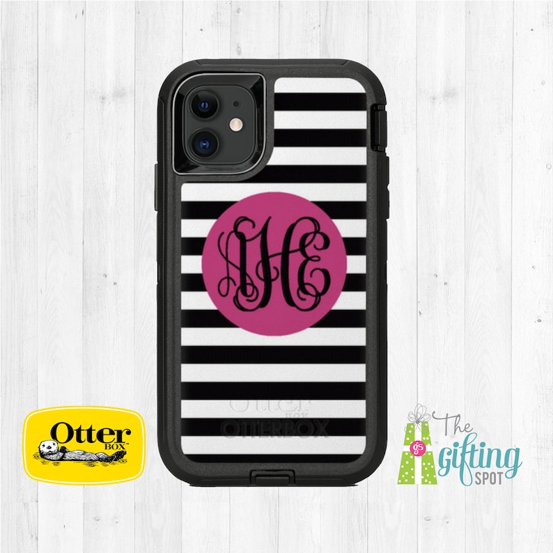 May include: Black and white striped phone case with a pink circle containing the monogram "JHC" in black script. The case is made by OtterBox.