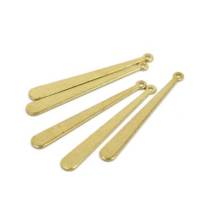 May include: Five gold-coloured metal pendant findings with a pointed tip and a small loop at the top.