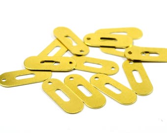 May include: A group of 10 brass key tags with a rectangular shape and a keyhole cutout. The tags are scattered on a white surface.