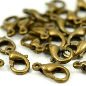 Peut inclure: Un tas de fermoirs à ressort en métal doré antique. Ces fermoirs sont couramment utilisés pour la fabrication de bijoux et l'artisanat.