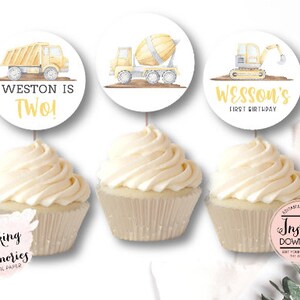 May include: Three cupcake toppers featuring yellow construction vehicles with the text "Weston is Two!" and "Wesson's First Birthday".