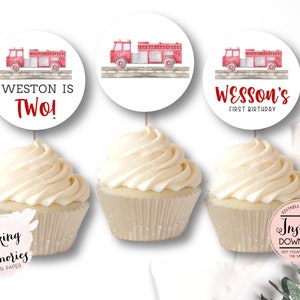 May include: Three cupcake toppers with red fire truck illustrations. The toppers say "Weston is Two!" and "Wesson's First Birthday".