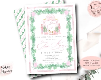 May include: A watercolor-style invitation for a first birthday celebration. The design features a pink and green color scheme with a decorative border of evergreen branches and pink accents. The text reads "Elise Ann's First Birthday" with event details.