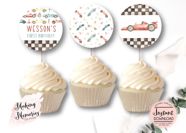 May include: Three cupcakes with toppers featuring race car designs. One topper says "Wesson's First Birthday" with race cars. Another has a pattern of race cars and flags. The third shows a red race car.