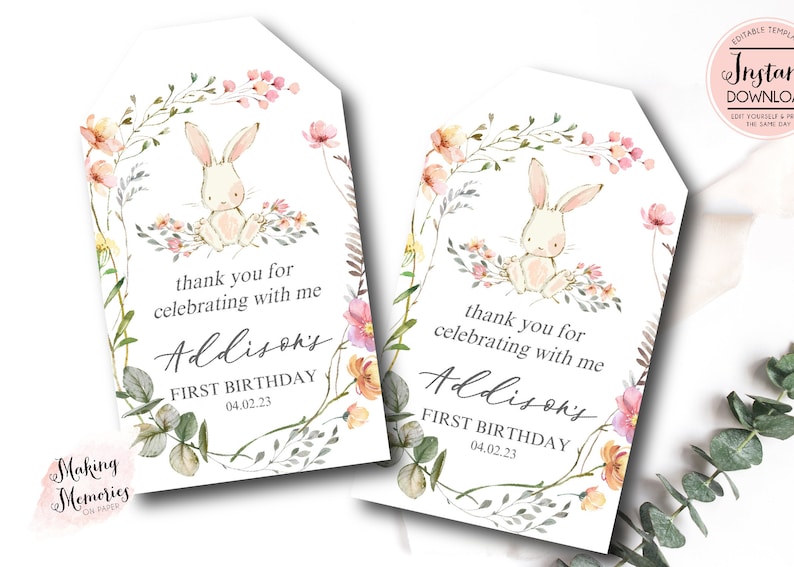 May include: Two printable thank you tags featuring a watercolor illustration of a bunny rabbit surrounded by flowers. The text reads "thank you for celebrating with me Addison's First Birthday 04.02.23".