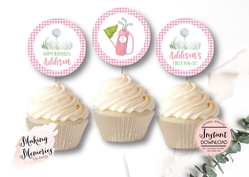May include: Three pink and white gingham cupcake toppers with a golf theme. The toppers feature a golf ball on a tee, a golf bag with clubs, and the text "Addison's First Par-Tee".