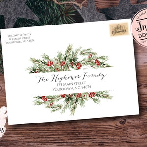 May include: White envelope featuring a watercolour design of evergreen branches and red berries. The text "The Highower Family" is centered, with address details below. Includes a postage stamp and a circular "Instant Download" graphic.