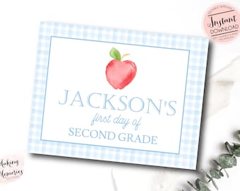 May include: A printable sign with a blue and white gingham background. The sign says "JACKSON'S first day of SECOND GRADE" with a red apple illustration.