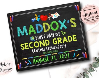 May include: A chalkboard sign with the text "Maddox's First Day of Second Grade" with colorful crayons and school supplies around the text. The sign also includes the text "Central Elementary" and "Mrs. Packs Class" and the date "August 21, 2021".