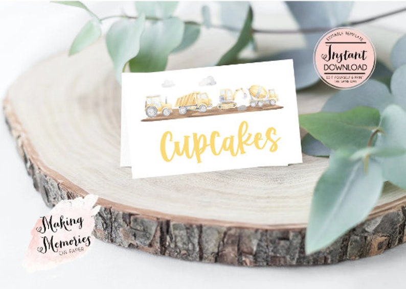 May include: A white card with a watercolor illustration of construction vehicles and the text "Cupcakes" in yellow.