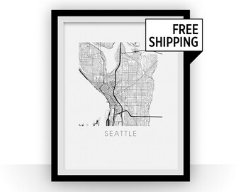 May include: Black and white line art map print of Seattle, Washington. The map shows the city streets and waterways. The print is framed in a black frame with a white mat. The text "Seattle" is printed below the map.