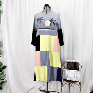 May include: A gray, black, yellow, and pink patchwork dress with a palm tree and sunset graphic print.