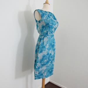 Lovely 1950s Turquoise Blue Floral Wiggle Dress with Graceful Wrap-Over Back & Rosette