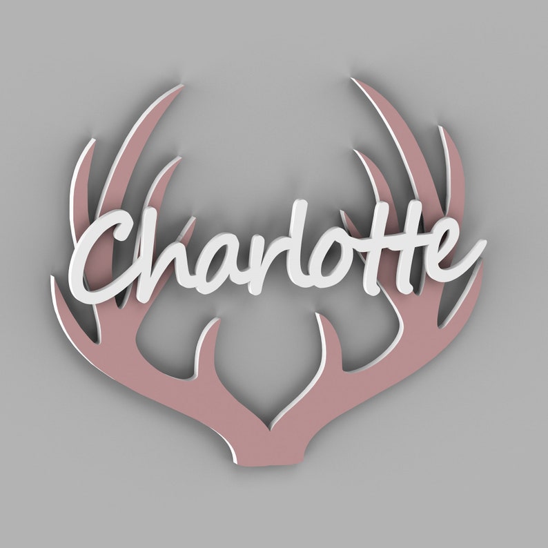 May include: A pink wooden antler design with the name "Charlotte" in white lettering.