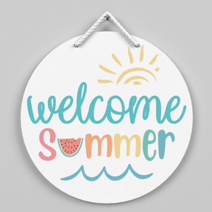 May include: A white round sign with a rope hanger. The sign says "welcome summer" in colorful letters with a watermelon slice and a sun graphic.