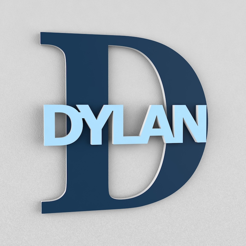 May include: A large navy blue letter D with the name DYLAN in light blue letters inside the letter. The letters are 3D and have a slightly raised texture.