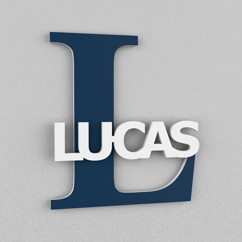May include: A navy blue letter L with the name "LUCAS" in white letters on top of it.