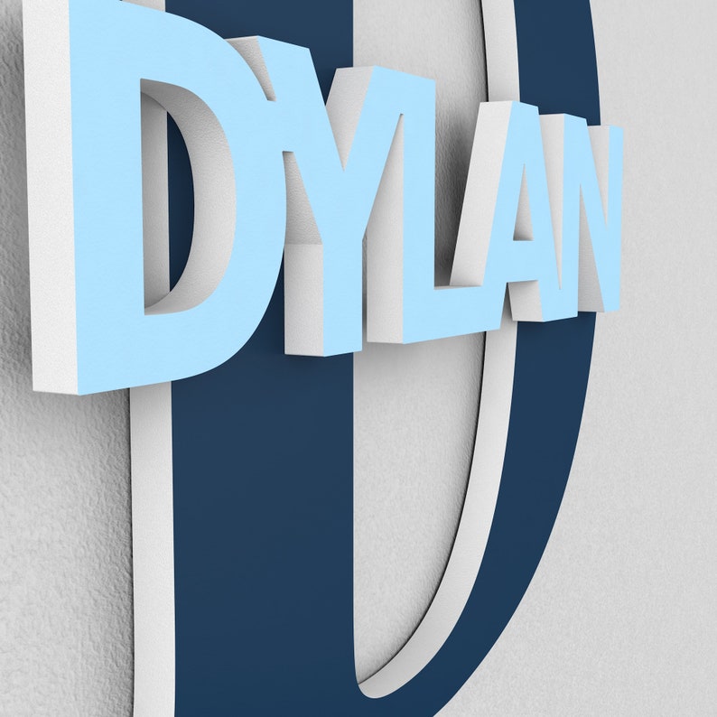 May include: A blue and white 3D name sign with the name "DYLAN" in white letters on a blue background. The letter "D" is a large, blue, 3D letter with a white outline.