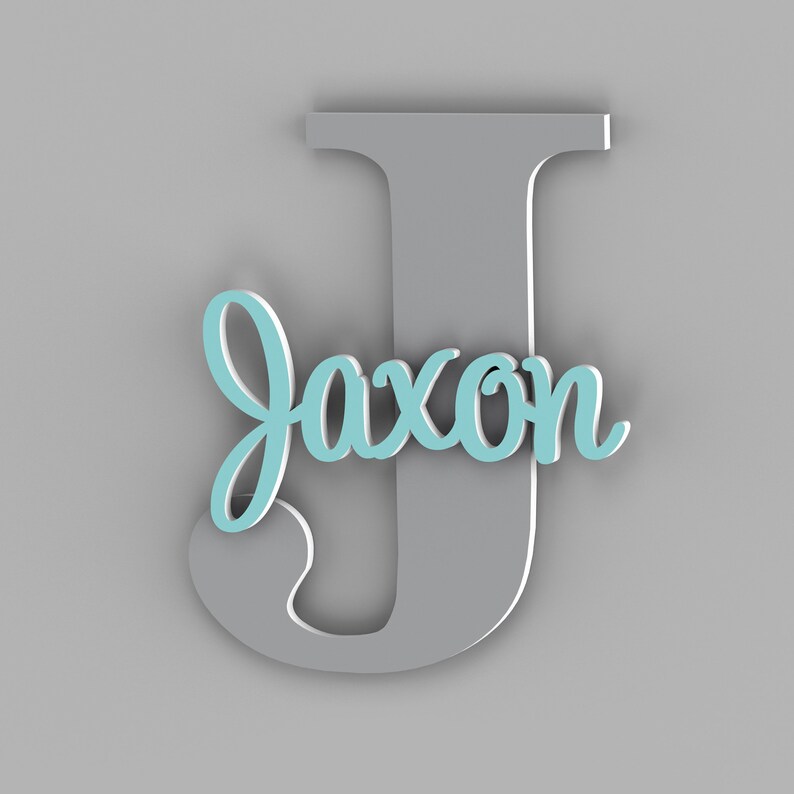 May include: A gray wooden letter J with the name "Jaxon" written in light blue on it.