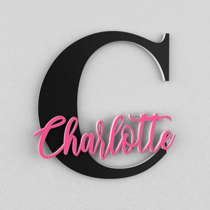 May include: Black wooden letter C with the name Charlotte in pink cursive lettering.
