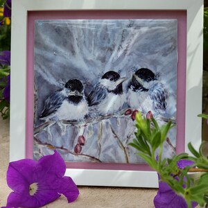 May include: Framed watercolor painting of three black-capped chickadees perched on a branch with red berries. The birds are in a snowy winter setting.