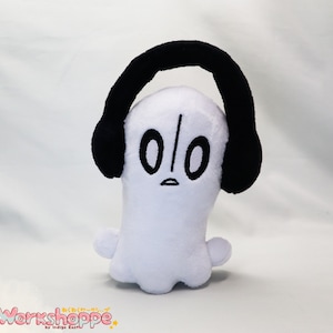 May include: White plush ghost with black headphones and a black embroidered face with the text "010".