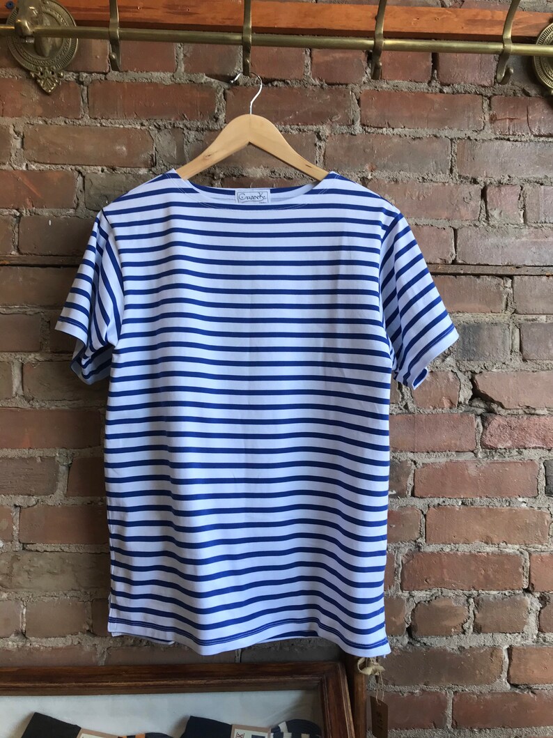 May include: A white and blue striped short-sleeved t-shirt with a small white label that says "Armor Lux" on the front.