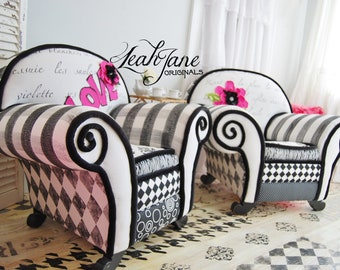 May include: Two black and white striped armchairs with pink floral accents. The armchairs have a unique design with black and white checkered fabric and a black and white swirl pattern on the arms. The armchairs are sitting on a black and white checkered floor.