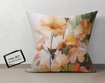 May include: A square pillow cover with a floral print featuring a variety of orange, yellow, and pink flowers. The background is a light beige color.