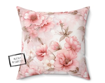 Puede incluir: Una almohada cuadrada rosa y blanca con un patrón floral. La almohada tiene un diseño floral rosa y blanco con tallos y hojas marrones. El texto "INSERT INCLUDED!!" está en una etiqueta negra en la esquina inferior izquierda de la almohada.