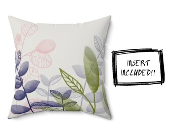 May include: A white throw pillow with a watercolor design of pink, green, and blue leaves. The pillow is a decorative accent for a home.