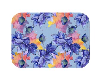 May include: Watercolor illustration of blue lotus flowers with yellow and orange watercolor splatters on a light blue background.