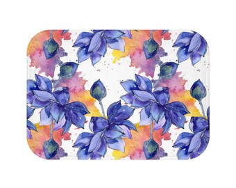May include: Watercolor illustration of blue lotus flowers with yellow and pink watercolor splatters on a white background.