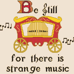 May include: A red and gold vintage-style carousel organ with a sign that reads "Be still for there is strange music".
