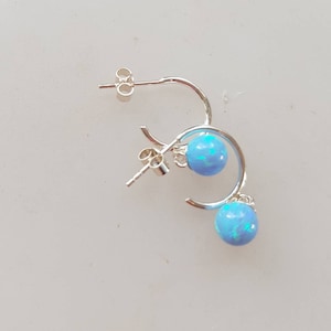 Gilson fire opal drop earrings in a half hoop design,  with  blue opal stones ,post and butterfly backs,