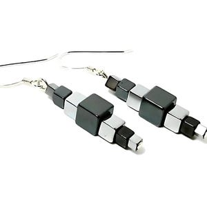 May include: A pair of silver dangle earrings with black and silver cube-shaped beads.