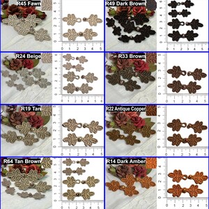 May include: A collection of decorative leaf-shaped embellishments in various colors, including fawn, dark brown, beige, tan, antique copper, and dark amber. Each design features a central pearl-like bead and is displayed with a ruler for size reference.