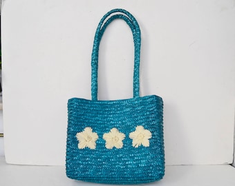 Blue straw bag with white flowers