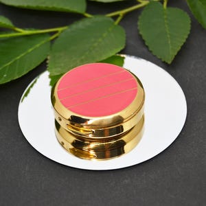Gold pocket pill box with elegant and compact design