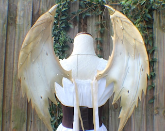 Custom layered foam Dragon wings in white and gold with sculpted claw tips