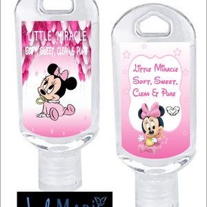 May include: Two clear plastic bottles with a pink and white label featuring a cartoon image of Minnie Mouse. The label reads "Little Miracle Soft, Sweet, Clean & Pure".